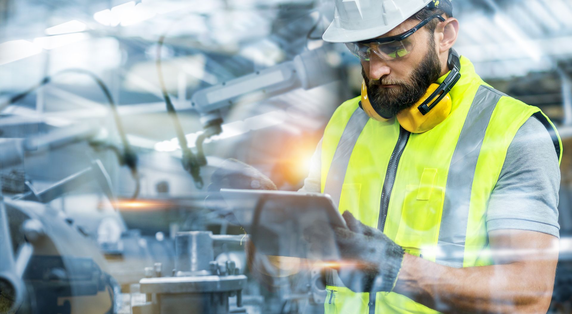 Field engineer in safety gear with tablet